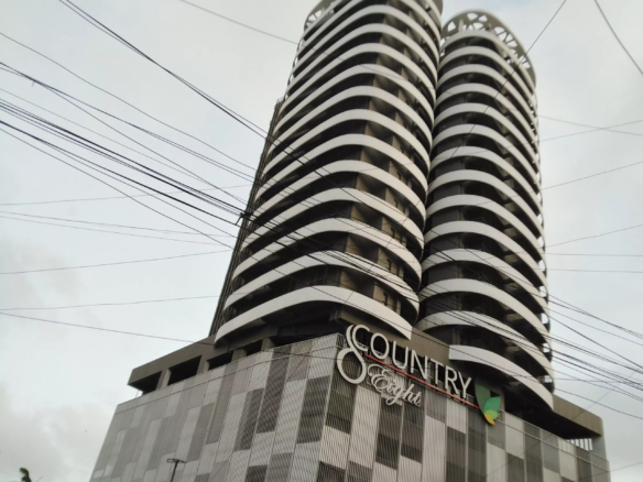 Modern Twin-Tower Apartment Building In Country 8 Clifton With Curved White Facades, Balconies, And Dark Accents