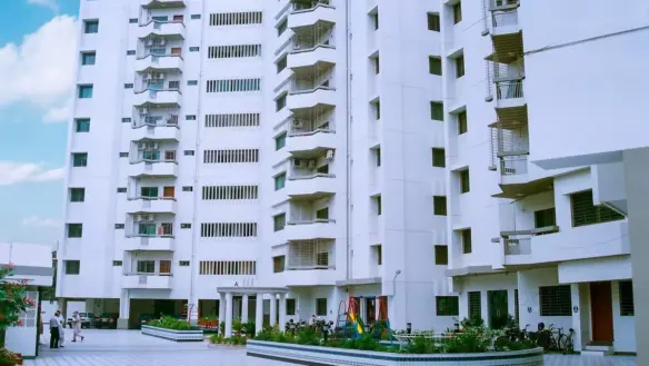 Mehran Twin Towers Exterior In Civil Lines: Multi-Story White Building With Balconies, Ac Units, And Ground-Level Courtyard W