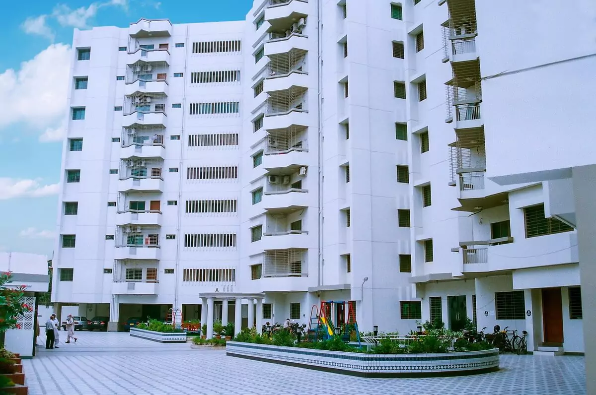Mehran Twin Towers exterior in Civil Lines: multi-story white building with balconies, AC units, and ground-level courtyard w