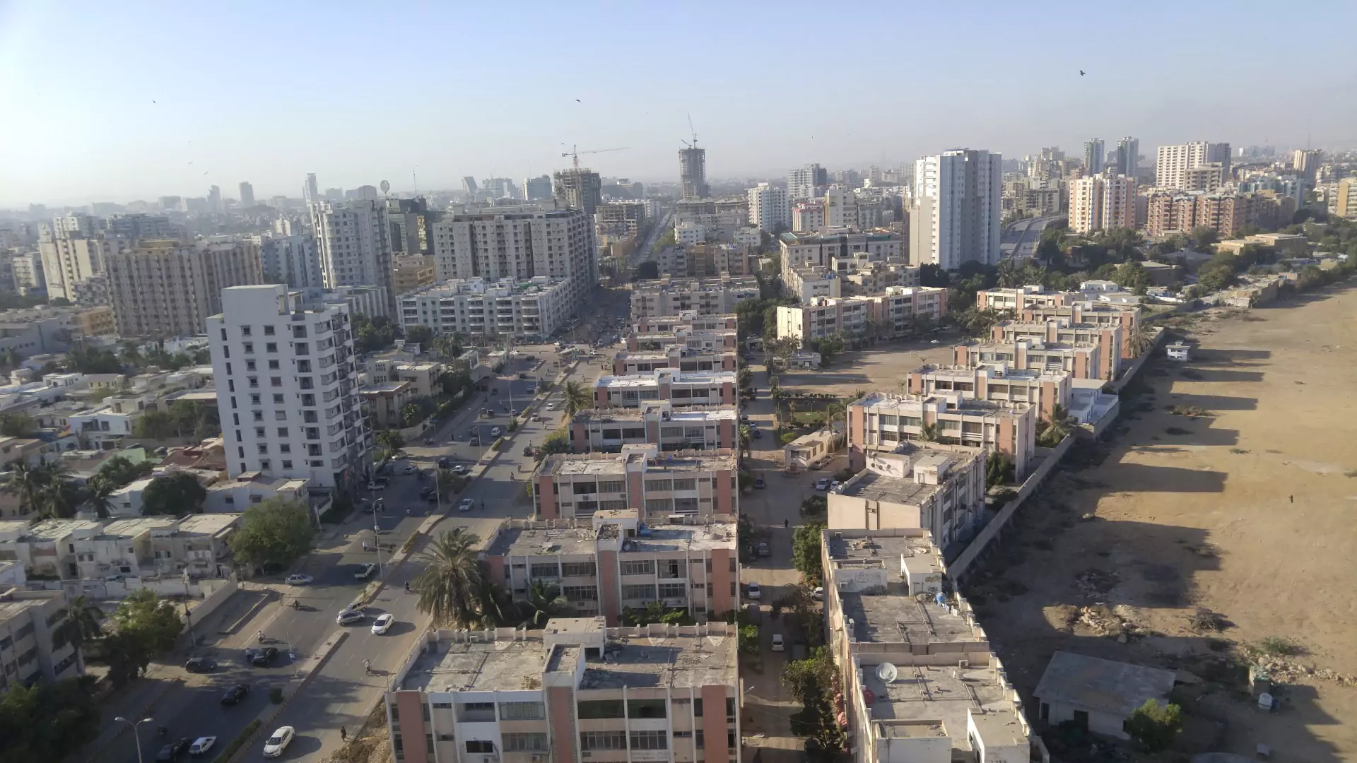 Luxurious Flat for Sale in Machiyara Tower Block 8 Clifton Karachi (2) Aerial view from 10th floor flat in Machiyara Tower Clifton showing surrounding apartment buildings, streets, high-rises, and