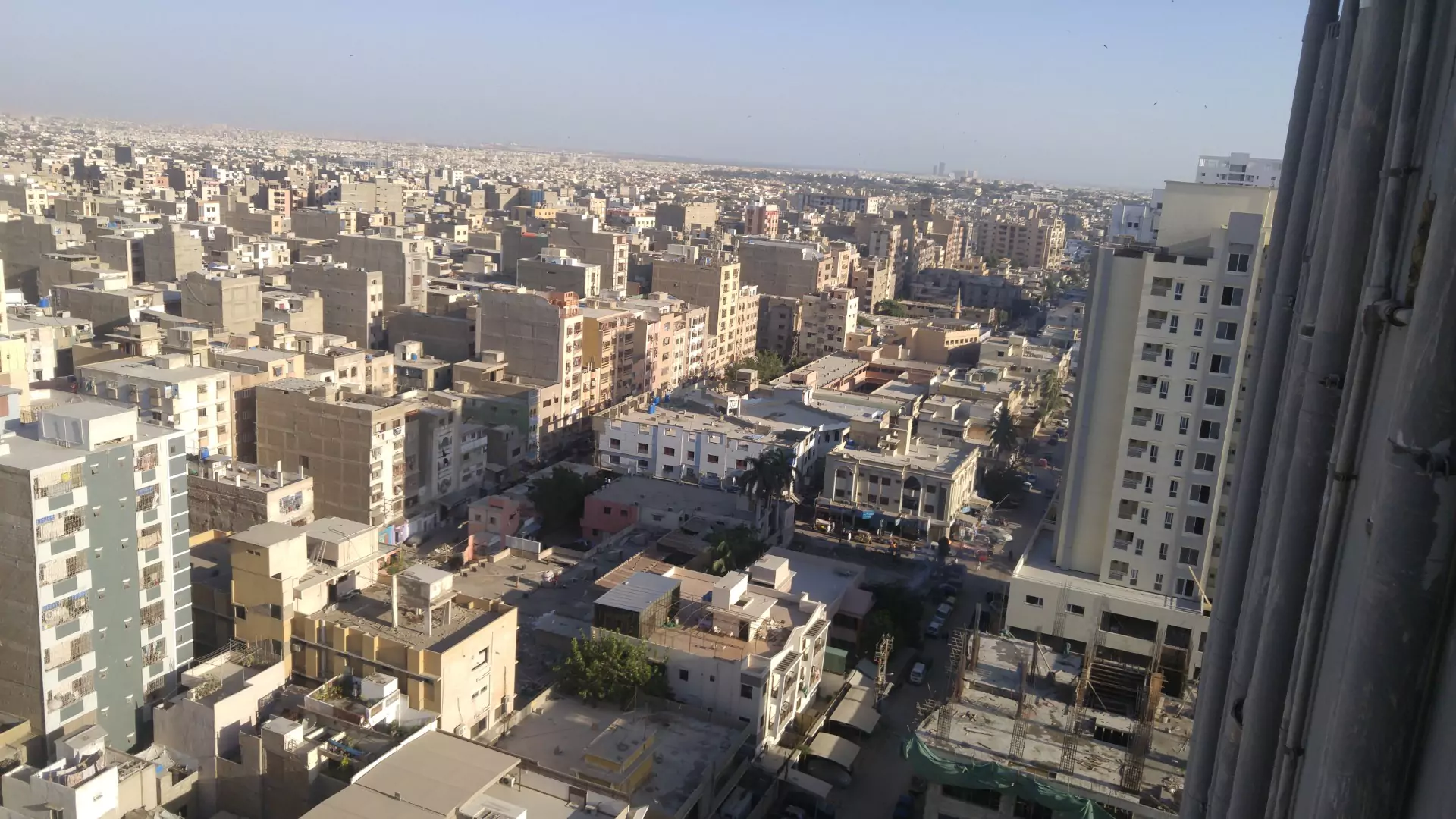 Luxurious Flat for Sale in Machiyara Tower Block 8 Clifton Karachi (4) Panoramic urban skyline view from 10th floor flat in Machiyara Tower Clifton, overlooking dense buildings and city streets