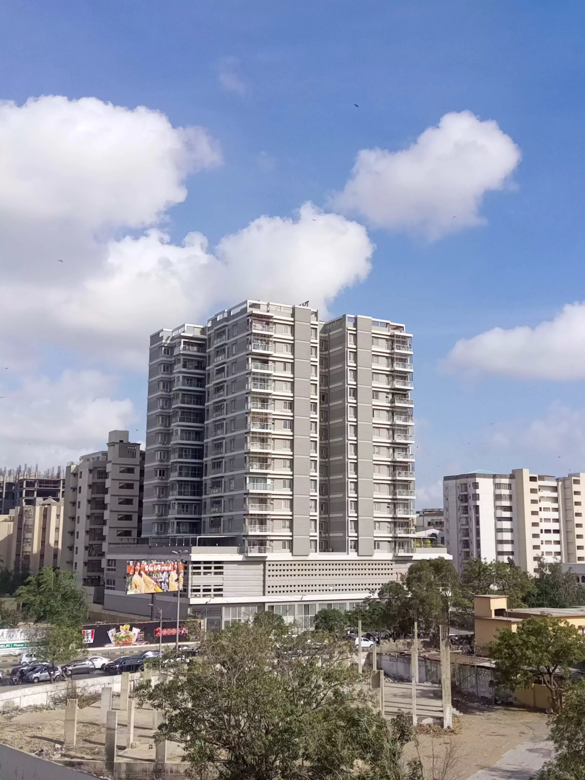 Dany Icon luxury high-rise towers in Civil Lines, modern grey multi-story building with balconies amid urban surroundings