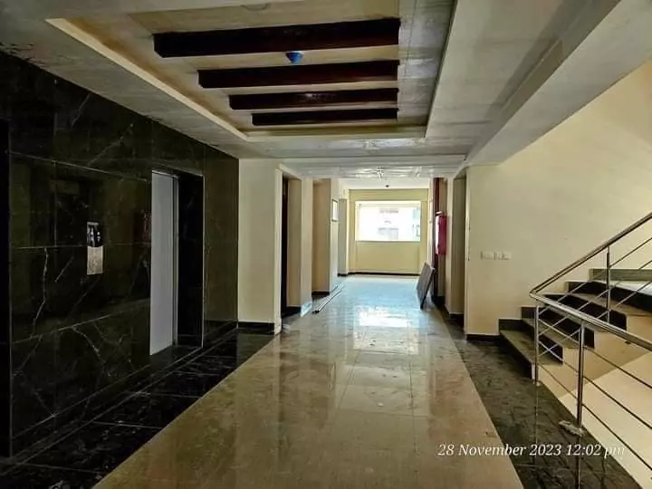 Luxurious 3 Bedroom Flat for Rent in Askari 5, Sector J Malir Cantonment Karachi (5) Spacious corridor with polished marble flooring, black marble walls, wooden beam ceiling, elevator and stairs in 3-bedroom fl