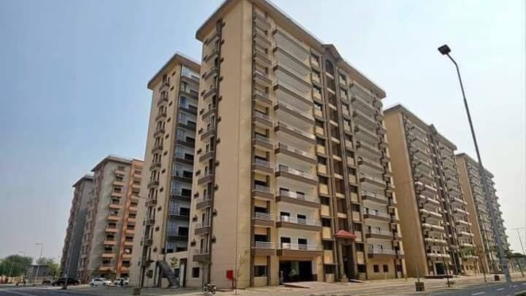 Multi-Story Beige Apartment Buildings In Askari 5 Karachi With Balconies, Glass Railings, Main Entrance, And Street View