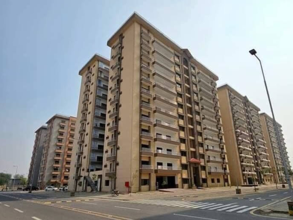 Multi-Story Beige Apartment Buildings In Askari 5 Karachi With Balconies, Glass Railings, Main Entrance, And Street View