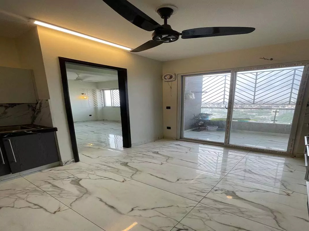 Luxurious 4-Bedroom Flat for Rent in Clifton Marina Block 7 Karachi (0) Modern high-rise at Clifton Marina Block 7 with grey facade, balconies, Clifton Marina signage, street view, parked vans and