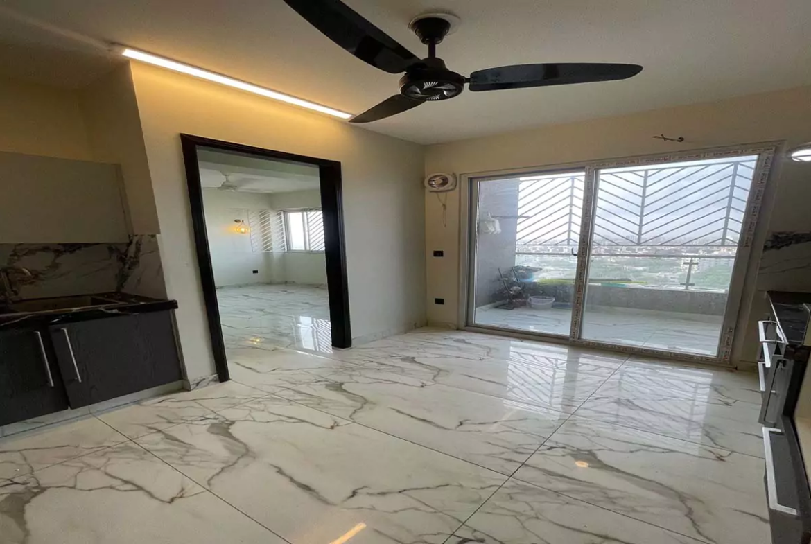 Luxury 3 Bed Flat For Rent In Clifton Marina Block 7 Karachi (3) Modern kitchen with grey cabinets, marble floors, ceiling fan, and balcony doors in luxury 3-bed flat, Clifton Marina Block 7