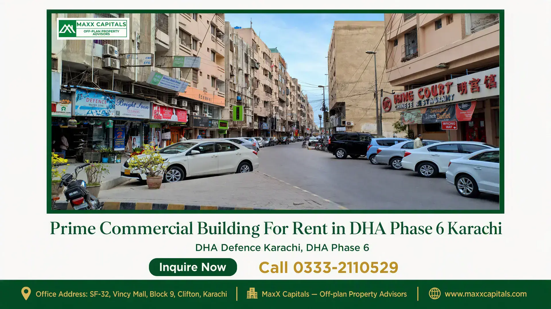 Prime Commercial Building For Rent in DHA Phase 6 Karachi Street view of a prime commercial building in DHA Phase 6 Karachi surrounded by parked cars and shops.