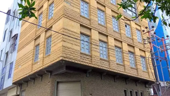 Beige Multi-Story Commercial Building For Rent In Dha Phase 6 Karachi, Corner Location With Textured Facade, Large Windows, A