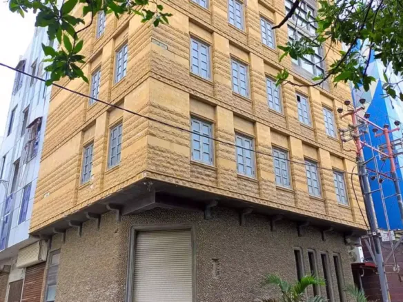 Beige Multi-Story Commercial Building For Rent In Dha Phase 6 Karachi, Corner Location With Textured Facade, Large Windows, A