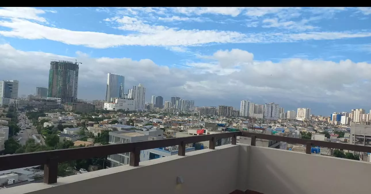 Luxurious 5-Bed Penthouse for Rent in Mall Square Zamzam – DHA Phase 5 Karachi (1) Panoramic city skyline view from 5-bed penthouse balcony in Mall Square DHA, high-rises under construction and blue skies
