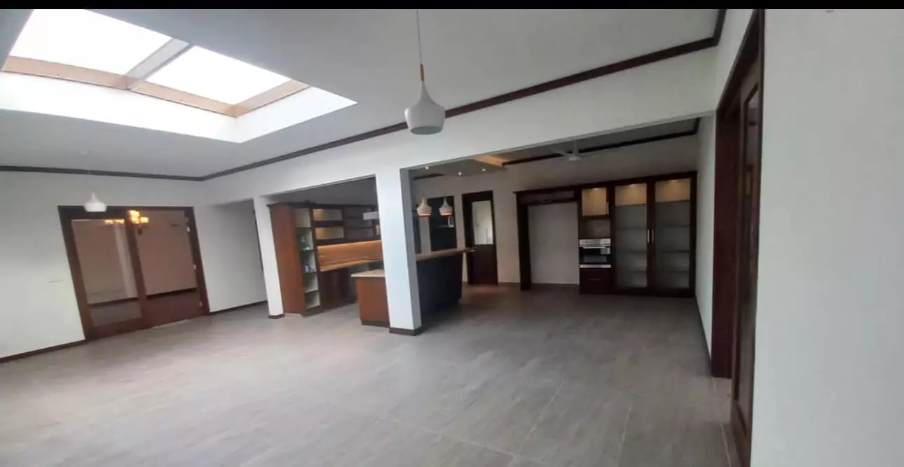 Luxurious 5-Bed Penthouse for Rent in Mall Square Zamzam – DHA Phase 5 Karachi (13) Spacious open-plan living and kitchen in 5-bed penthouse for rent in Mall Square DHA with skylight, pendant lights, built-in