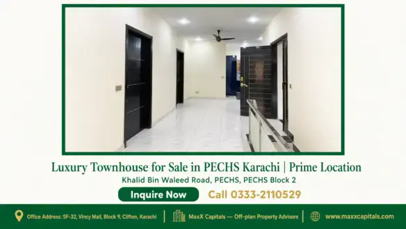 Spacious hallway in a luxury townhouse with tiled flooring, modern black doors, and well-lit ceiling in PECHS Karachi.