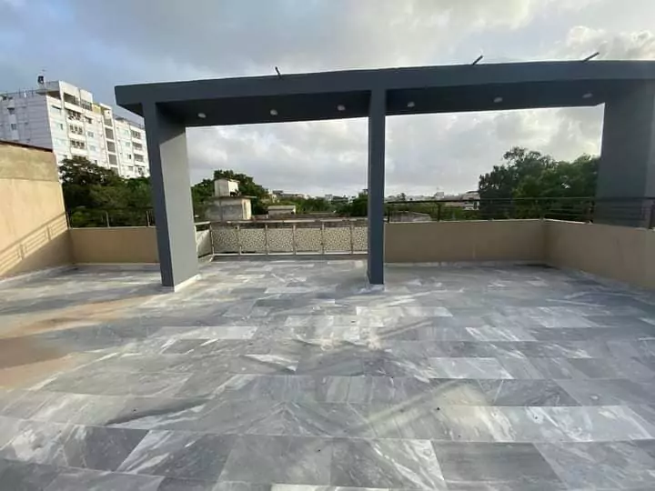 Luxury Townhouse for Sale in PECHS Block 2 Main Khalid Bin Waleed Road Karachi at Prime Location (2) Spacious rooftop terrace with grey marble flooring, black railings and pillars in luxury townhouse for sale in PECHS Karachi