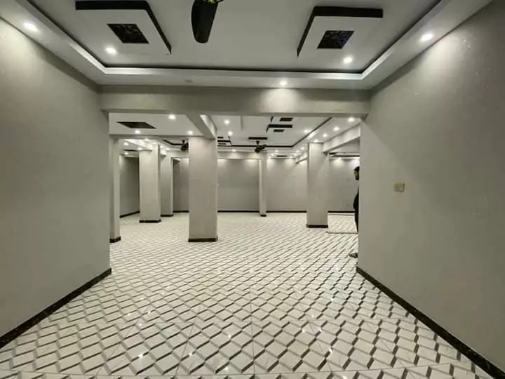Luxury Townhouse for Sale in PECHS Block 2 Main Khalid Bin Waleed Road Karachi at Prime Location (3) Spacious marble-floored hall with modern recessed lighting, ceiling fans, and pillars in PECHS townhouse for sale