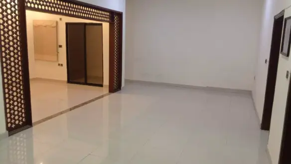 Spacious Living Area With Ornate Wooden Lattice Archway, Glossy White Tiled Floors In Luxury 3-Bedroom Portion For Rent In Pe