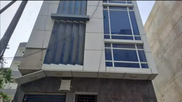 Modern 1100 Sqft Office Exterior In Dha Phase 7 With Large Blue-Tinted Windows, Vertical Sunshades, And Ground Floor Entrance