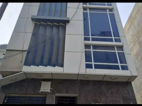 Modern 1100 Sqft Office Exterior In Dha Phase 7 With Large Blue-Tinted Windows, Vertical Sunshades, And Ground Floor Entrance