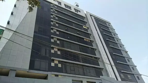 Multi-Story Luxury Office Building Facade In Clifton Diamond, Featuring Tinted Glass Windows, White Panels, And Modern Design