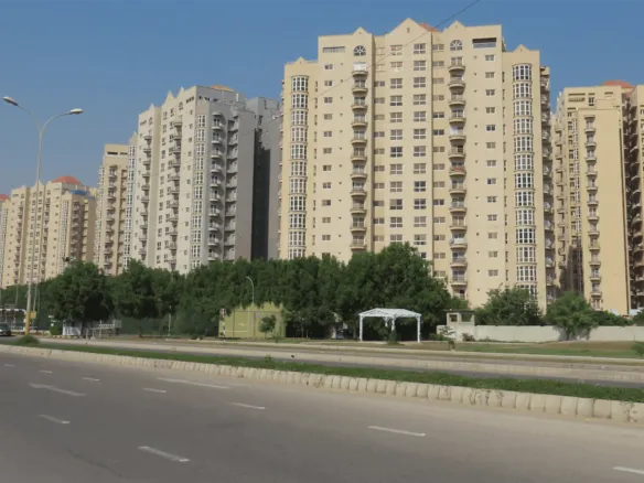 Creek Vista Apartments High-Rise Towers In Dha Phase 8 Karachi, Modern Beige Buildings With Balconies Along Tree-Lined Road
