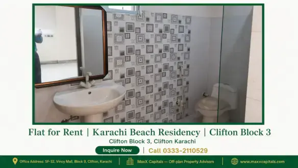 Modern bathroom with a ceramic basin, mirrored vanity, tiled backsplash, glass shower door, and commode in Karachi Beach Resi