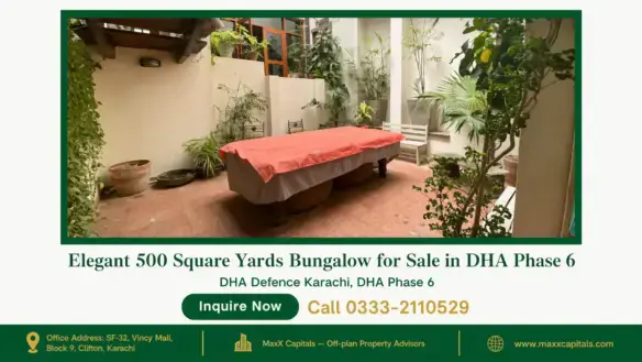Spacious outdoor patio with red-tile flooring, lush green plants, and a covered table in a bungalow for sale in DHA Phase 6.
