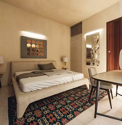 The Nishat Residency Dha Phase 6 Defence Karachi (12) Luxury bedroom in Nishat Residency DHA Phase 6 Karachi with beige upholstered king bed, modern desk, artwork, mirrored wall,