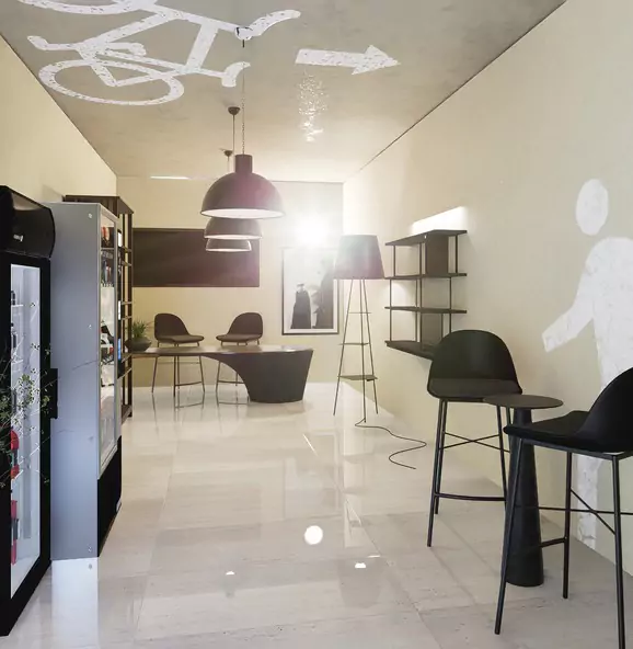 The Nishat Residency Dha Phase 6 Defence Karachi (4) Modern lounge in Nishat Residency DHA Phase 6 Karachi with bicycle ceiling art, black chairs tables, pendant lights, beverage