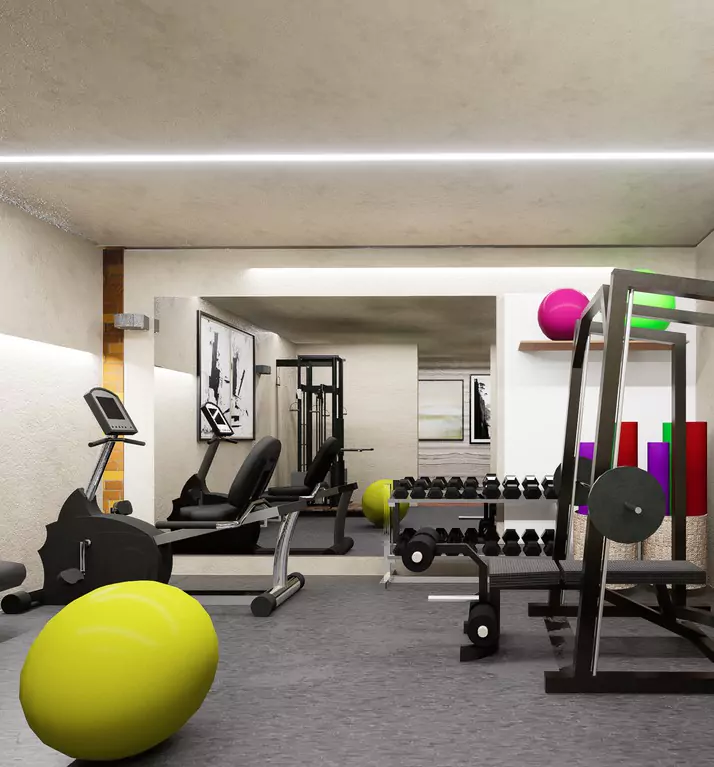 The Nishat Residency Dha Phase 6 Defence Karachi (5) Modern gym in Nishat Residency apartments, DHA Phase 6, Karachi, with recumbent bikes, weights, squat racks, dumbbells, and e
