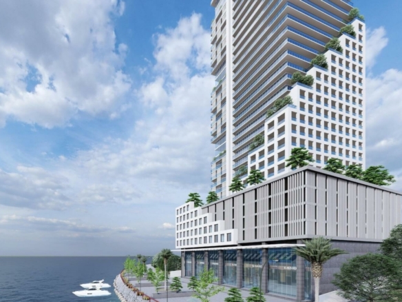 Metro SeaFront high-rise tower in DHA Phase 8, Karachi, with glass facades, terraced balconies and greenery under blue sky