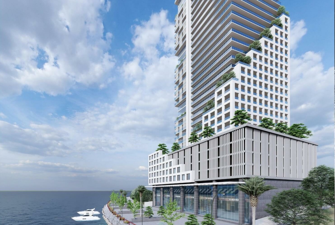 Metro Sea Front Redefining Luxury at HMR Waterfront, DHA Phase 8, Karachi (2) Metro SeaFront high-rise tower in DHA Phase 8, Karachi, with glass facades, terraced balconies and greenery under blue sky