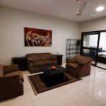 Living Room With Brown Leather L-Shaped Sofa, Armchairs, Coffee Table, Ceiling Fan, Wall Art, Sliding Glass Door To Bedroom I