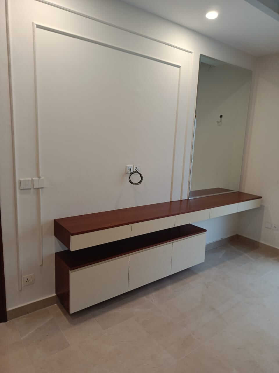 Brand New Stylish Bungalow For Rent in DHA Phase 4 Karachi (6) Modern wooden vanity with brown countertop, white cabinets, large framed mirror and recessed lighting in brand new stylish bu