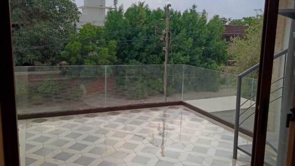 Spacious Modern Balcony With Diamond-Patterned Tiles, Glass Railings, Metal Staircase In Bungalow For Rent In Dha Phase 4 Kar