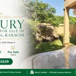 Bungalow For Sale In Dha Phase 6, Karachi Featuring A Lush Green Lawn, Stone Detail, And Tiled Outdoor Area With Beige Facade