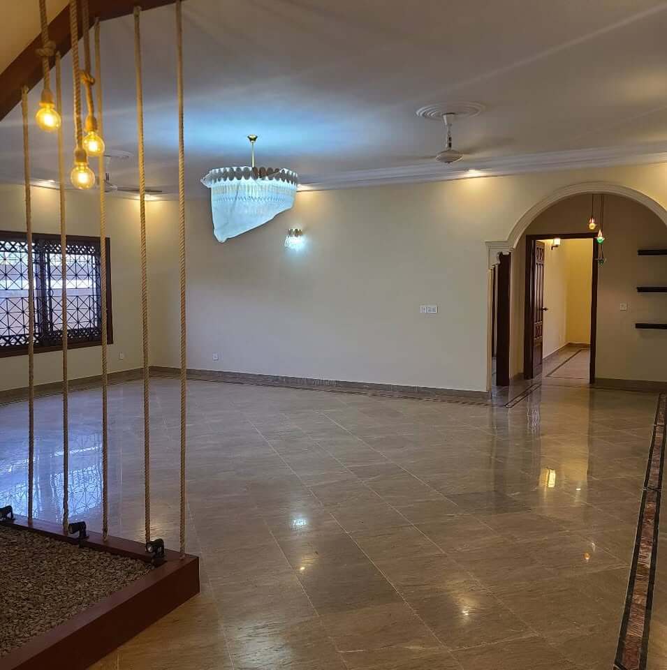 Supreme Luxury Bungalow for Sale in DHA Phase 6, Karachi (8) Spacious living room in luxury bungalow DHA Phase 6 with wooden rope staircase, hanging lights, ceiling fan, marble floor, ar