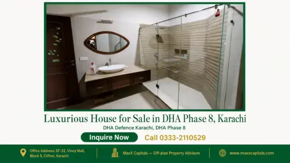 Modern bathroom in a house for sale in DHA Phase 8 with a large glass shower area, wooden vanity, and oval mirror.