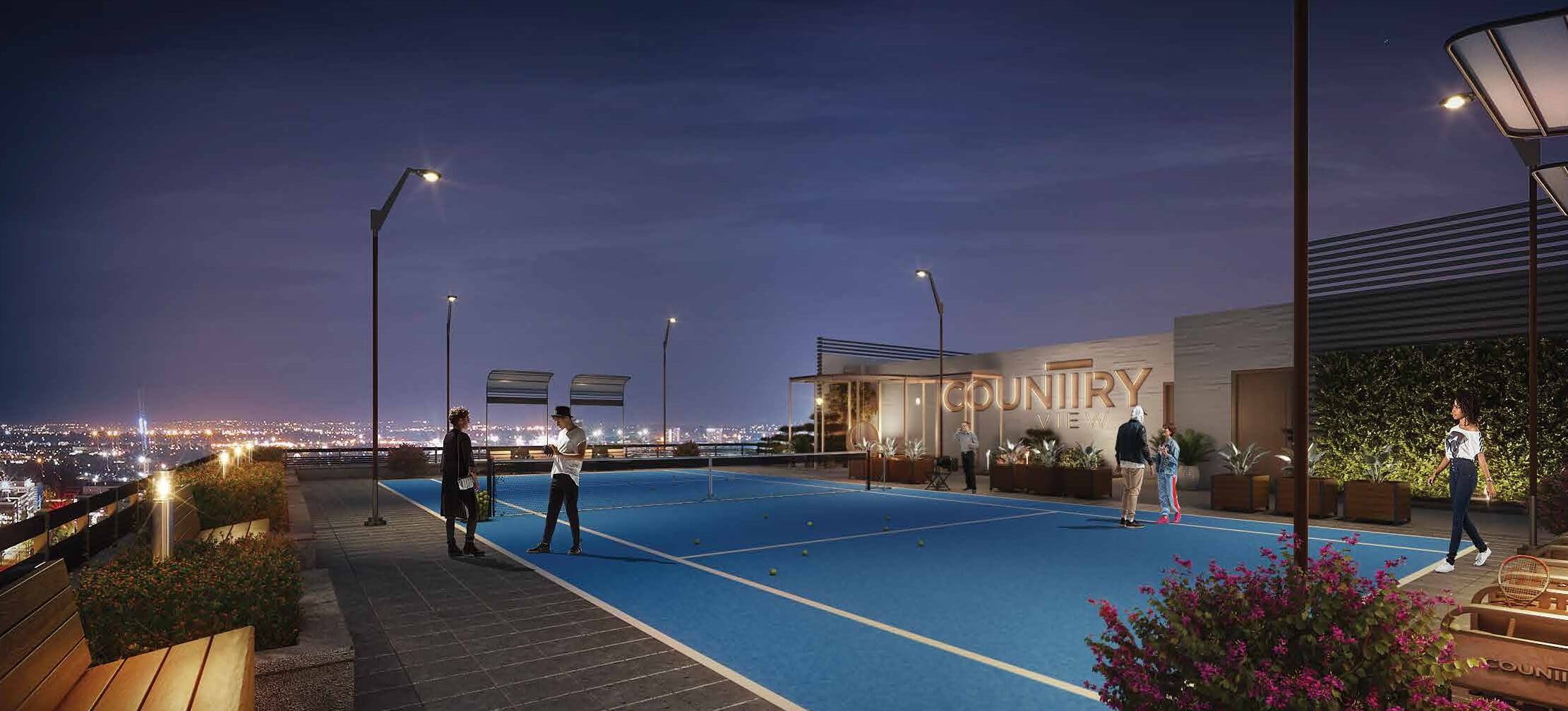 Country Naval View 2 Apartments Block 9 Clifton Karachi (1) Rooftop tennis court at Country Naval View luxury apartments in Clifton at night, blue court with players, city skyline view