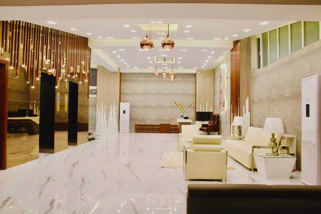 Luxurious lobby with marble floors gold elevators white leather seating in penthouse Clifton Block 7 Karachi