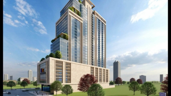Modern High-Rise Office Tower In Balad Trade Centre With Glass Facade, Green Terraces, Stone Base, And Landscaped Grounds Wit