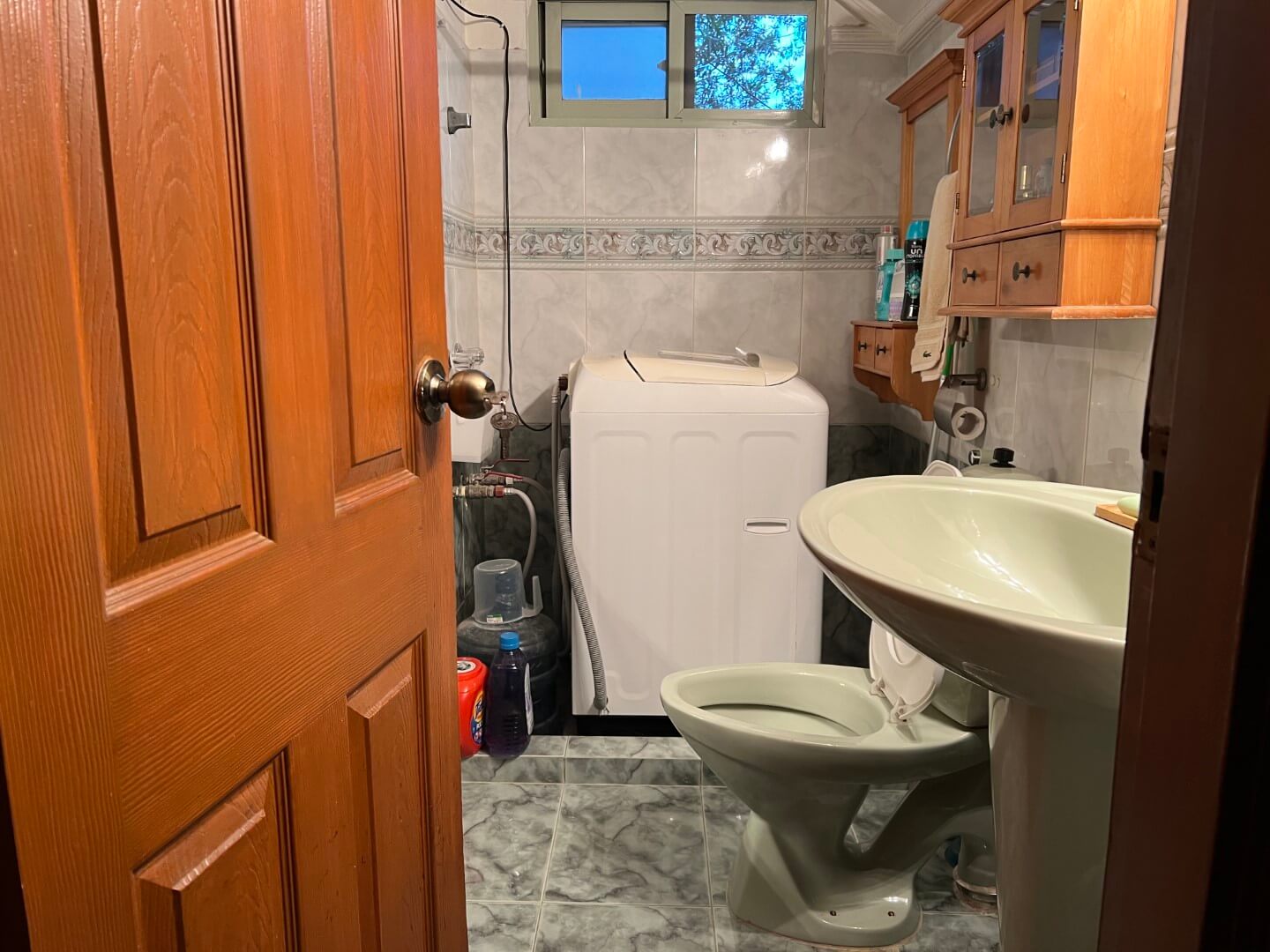 Portion for Rent in DHA Karachi – Fully Furnished Prime Location MaxX Capitals (3) Bathroom in fully furnished portion for rent in DHA Karachi with white washing machine, sink, toilet, shower, tiled walls and
