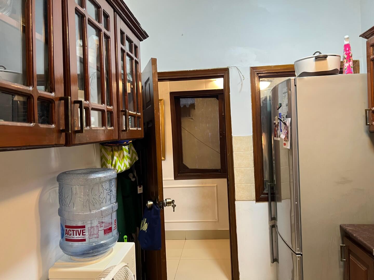 Portion for Rent in DHA Karachi – Fully Furnished Prime Location MaxX Capitals (5) Fully furnished kitchen in Portion for Rent in DHA Karachi with wooden cabinets, double door fridge, water dispenser