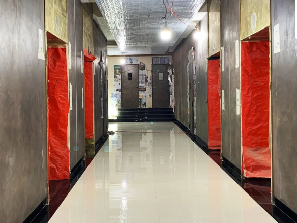 Long corridor in Chapal Skymark 50-storey tower with glossy white floors, gray walls, Chapal Skymark branding, red protective