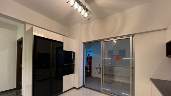 MaxX Capitals modern kitchen in Greens 3 Clifton apartment with black built-in appliances and sliding glass door