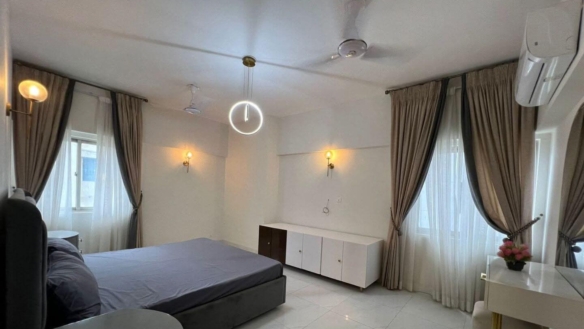 MaxX Capitals bedroom in Greens 3 Clifton apartment with twin windows, curtains, ceiling fans and air conditioner