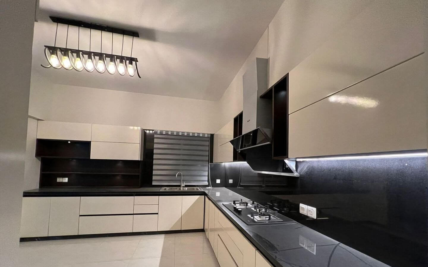 4-Bed Apartment for Sale in Greens 3 Clifton Block 8 MaxX Capitals modern modular kitchen in 4 bed apartment for sale Greens 3 Clifton with black countertops