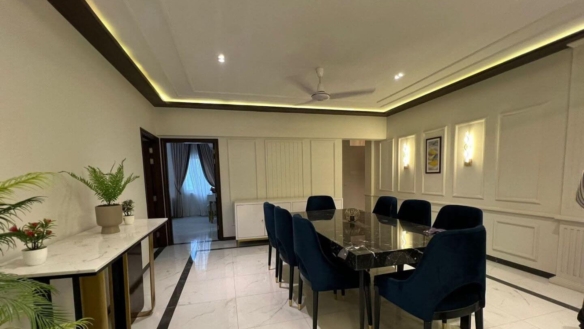 MaxX Capitals Clifton Block 8 apartment dining room with black table, blue chairs and modern wall paneling